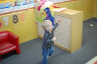 dsc_5917.jpg After intially being a little scared, and sitting away from everybody in the corner, Devin decides to join in the action.