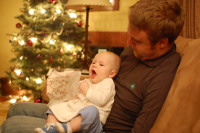 dsc_9948.jpg Devin opens his first Christmas presents.  Of everything, he likes the plastic bag the most!